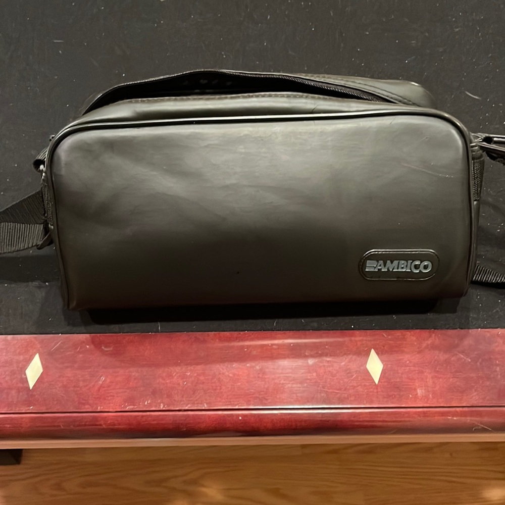 Black zip up camera bag with carry strap